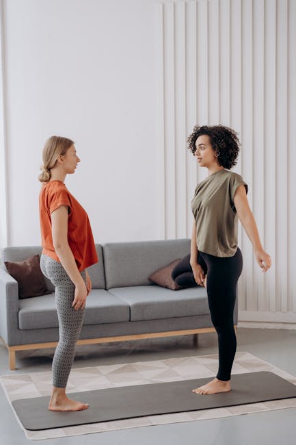 Two women of different ages practicing yoga together at home.